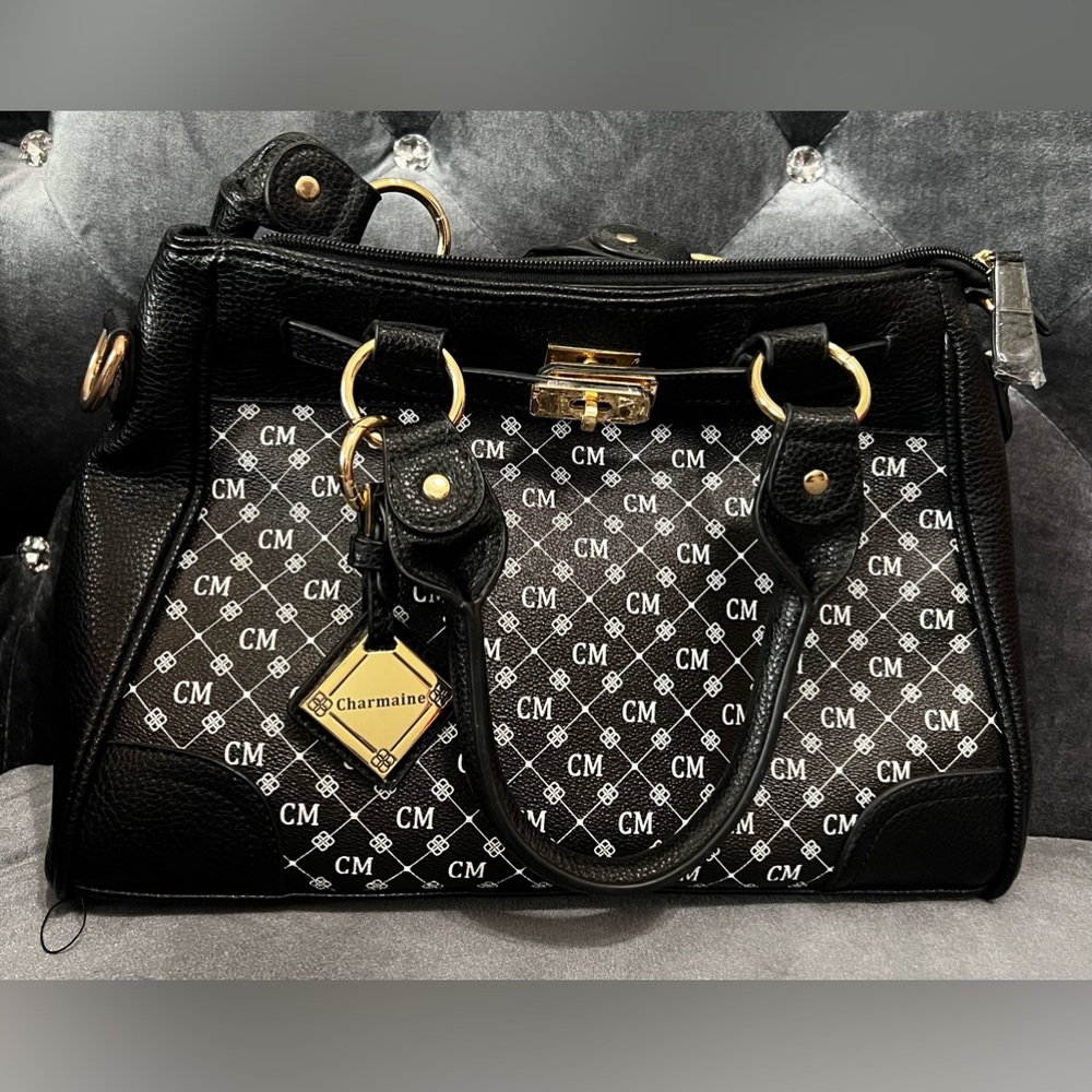 New, never used large black purse with white CM and gold trim.